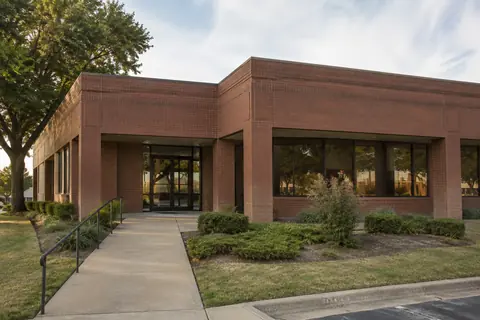 Single-story brick commercial property and its concrete approach, illustrative image