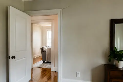 Subtle drywall crack above an interior doorway, illustrative image