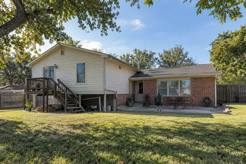 Older raised home connected to a later brick addition