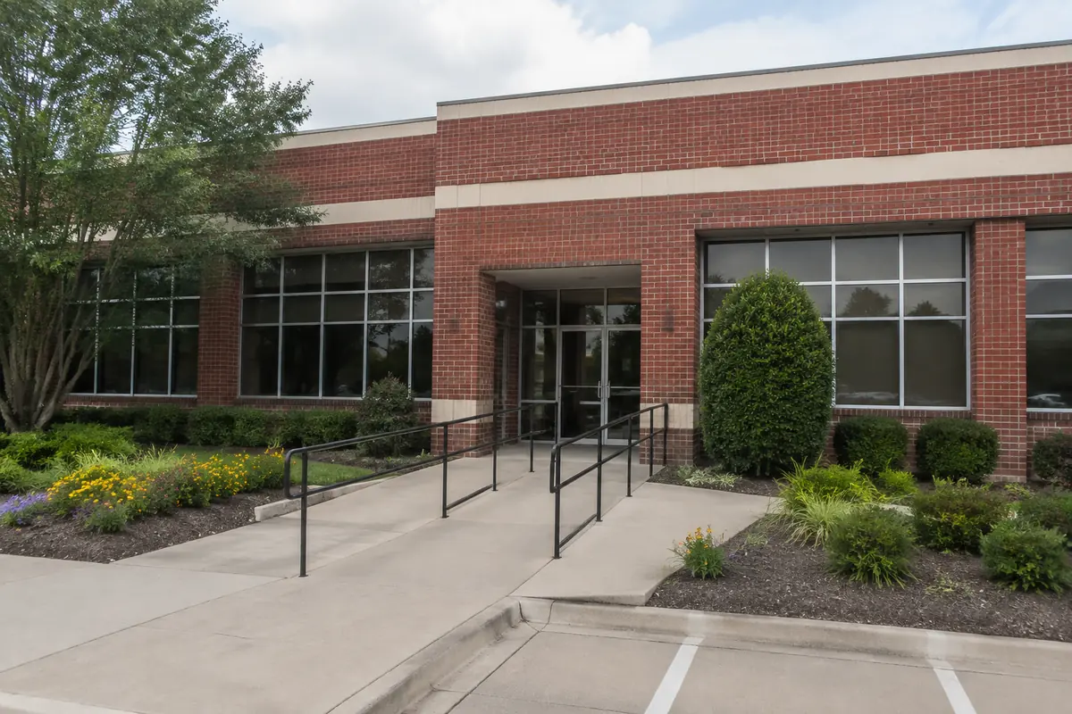 Unbranded brick civic-style building and entry walk, illustrative image