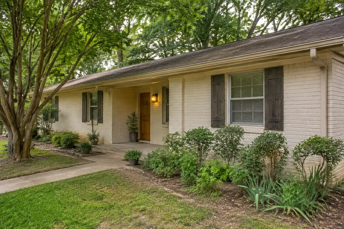 Brick home with a landscaped front yard in a North Texas-style neighborhood
