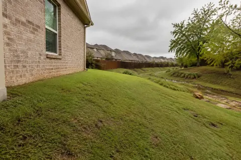 Graded yard beside a brick house, illustrative image
